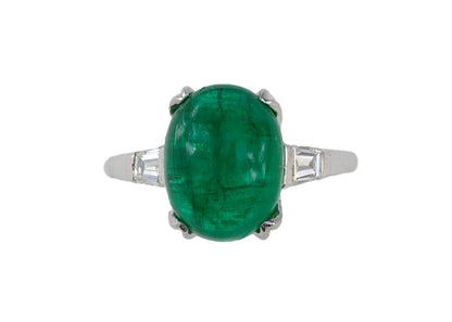 Platinum Oval Cabochon Emerald and Tapered Baguette Diamond Three-Stone Ring