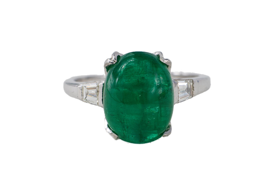 Platinum Oval Cabochon Emerald and Tapered Baguette Diamond Three-Stone Ring