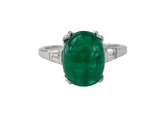 Platinum Oval Cabochon Emerald and Tapered Baguette Diamond Three-Stone Ring