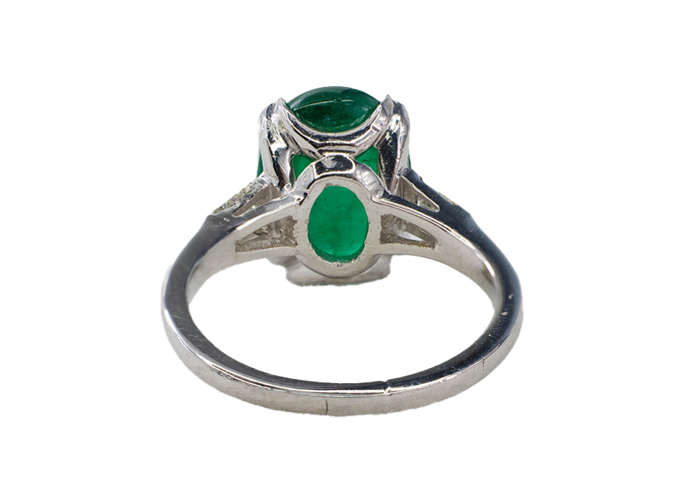 Platinum Oval Cabochon Emerald and Tapered Baguette Diamond Three-Stone Ring