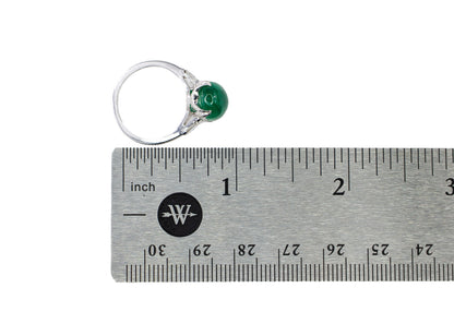 Platinum Oval Cabochon Emerald and Tapered Baguette Diamond Three-Stone Ring