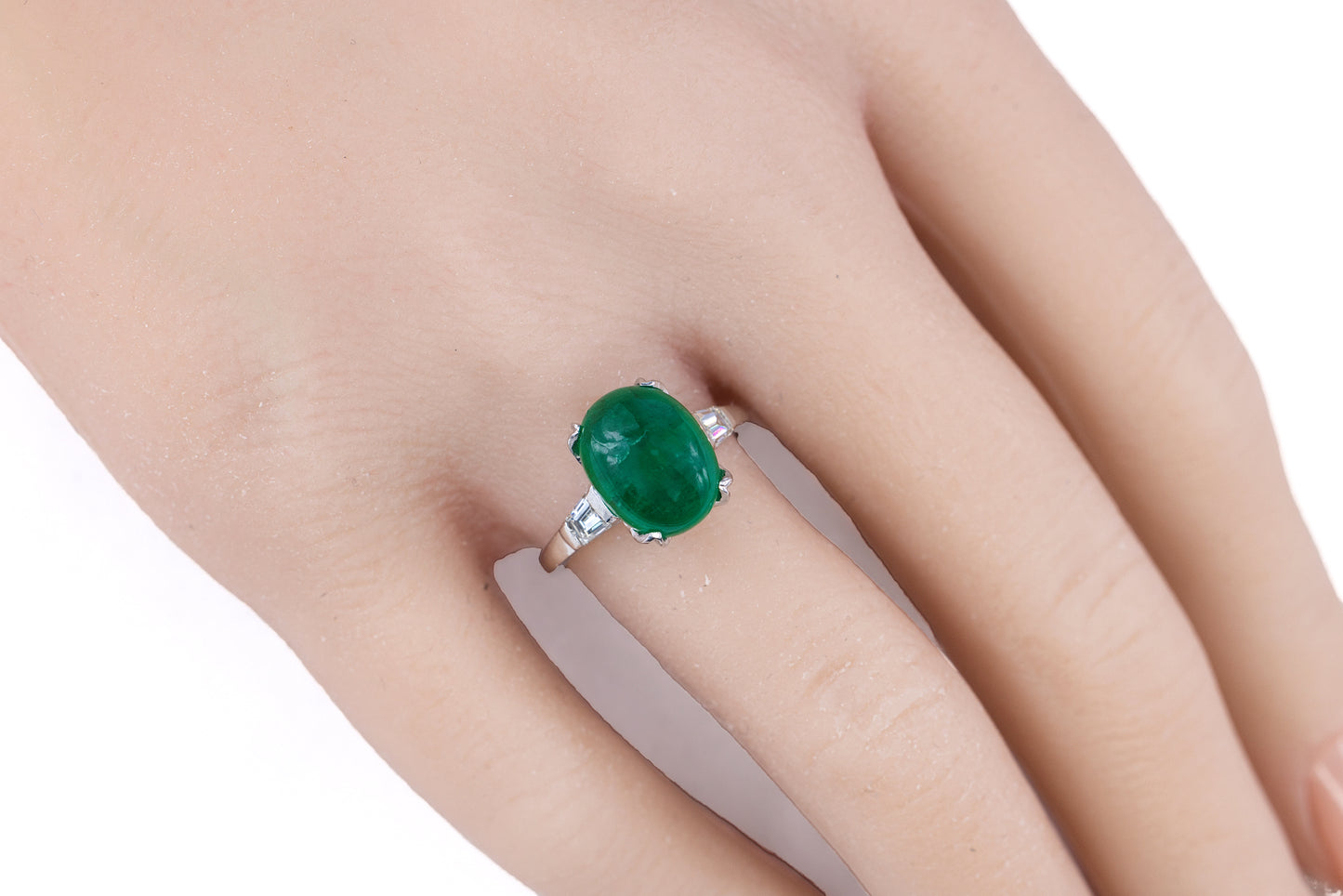 Platinum Oval Cabochon Emerald and Tapered Baguette Diamond Three-Stone Ring